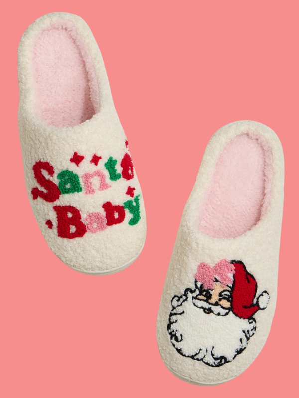 Pair of slippers with 'Santa Baby' text and Santa Claus design on a pink background