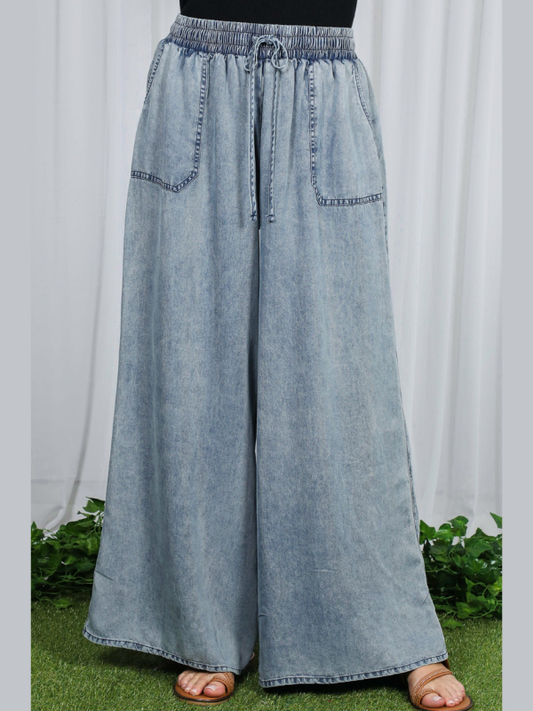 Light blue denim wide-leg pants on a white background