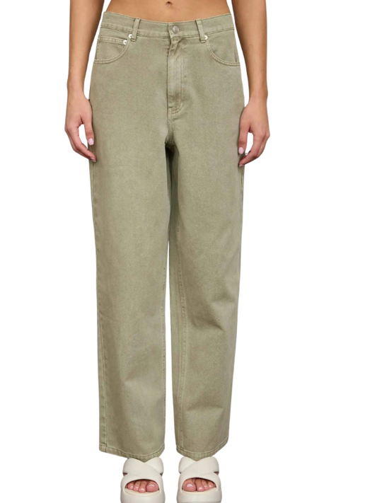 Person wearing light green jeans on a white background