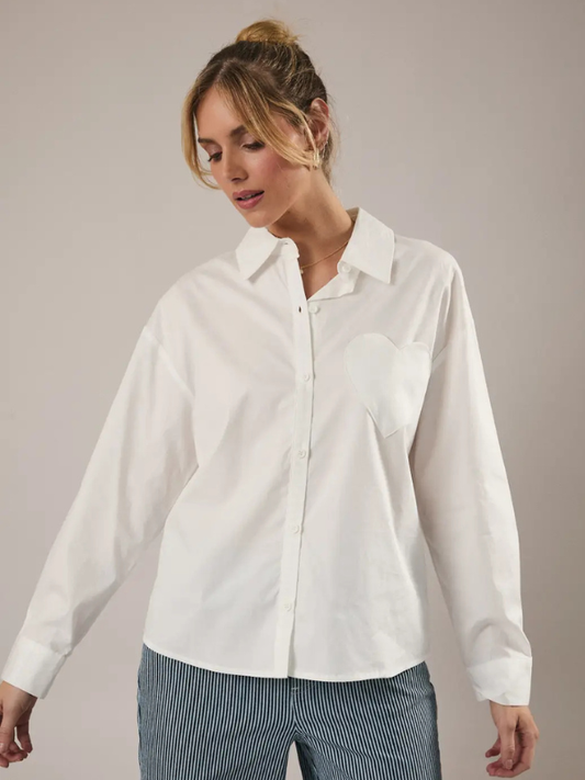 Woman wearing a white shirt against a plain background