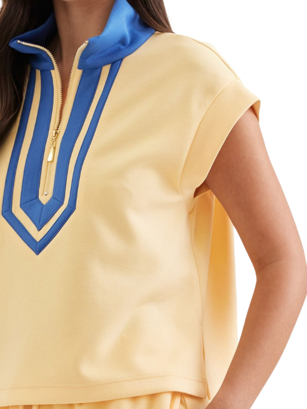 Yellow top with blue accents on a white background