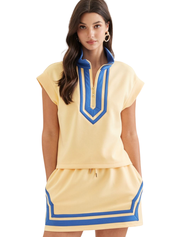 Woman wearing a yellow dress with blue accents on a white background