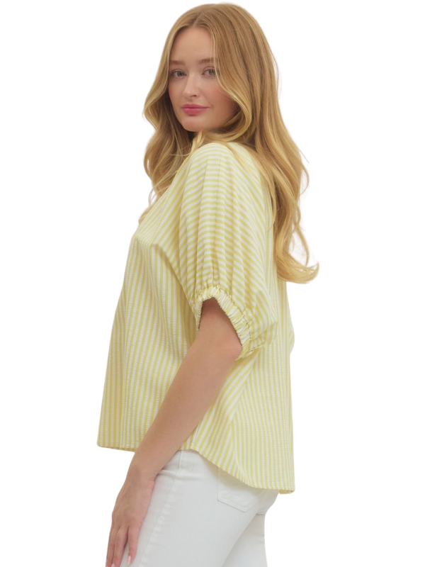 Woman wearing a yellow striped shirt on a white background