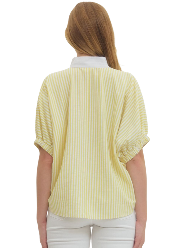 Woman wearing a yellow striped shirt on a white background